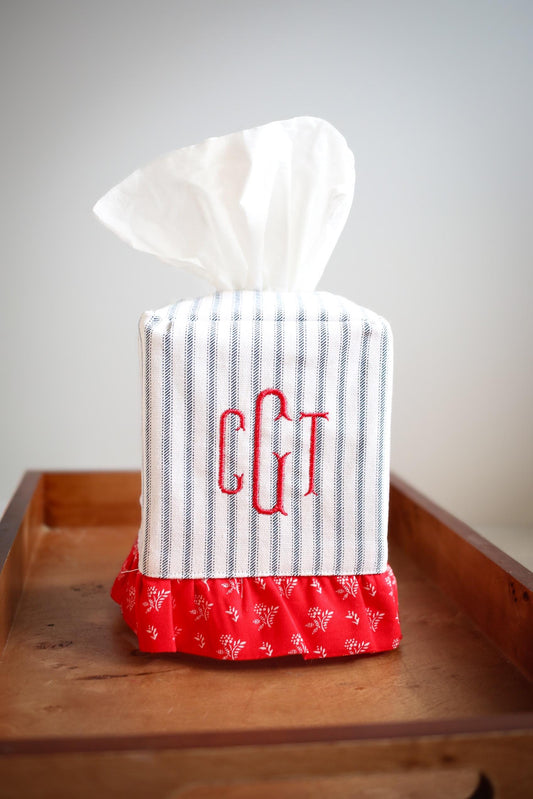 blue ticking stripe tissue box cover with red ruffle detailing and red custom embroidered monogram on wooden tray