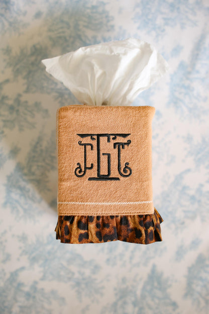 camel stripe tissue box cover with cheetah ruffle detailing and black custom embroidered monogram on blue toile background