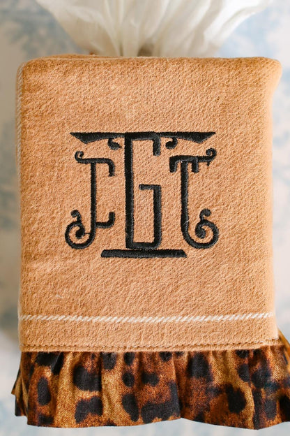 camel stripe tissue box cover with cheetah ruffle detailing and black custom embroidered monogram on blue toile background