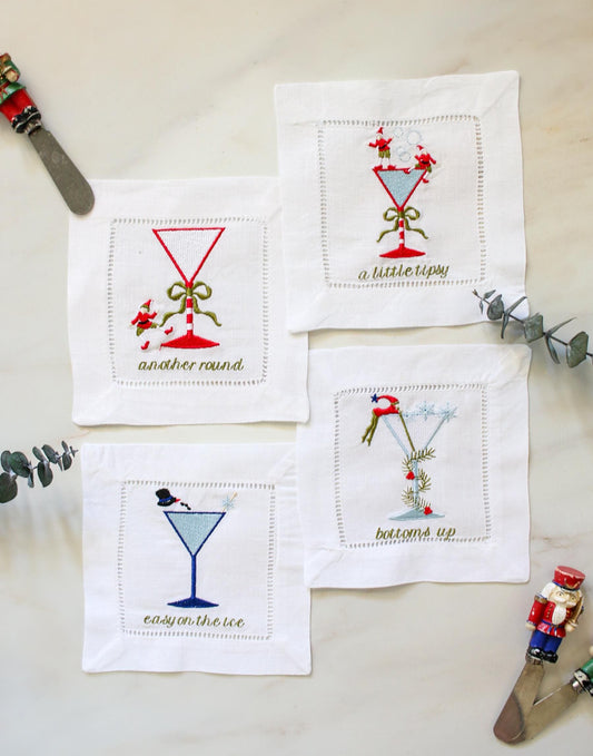 Set of 4 embroidered linen cocktail napkins – whimsical Christmas martini glass designs, perfect for holiday entertaining.