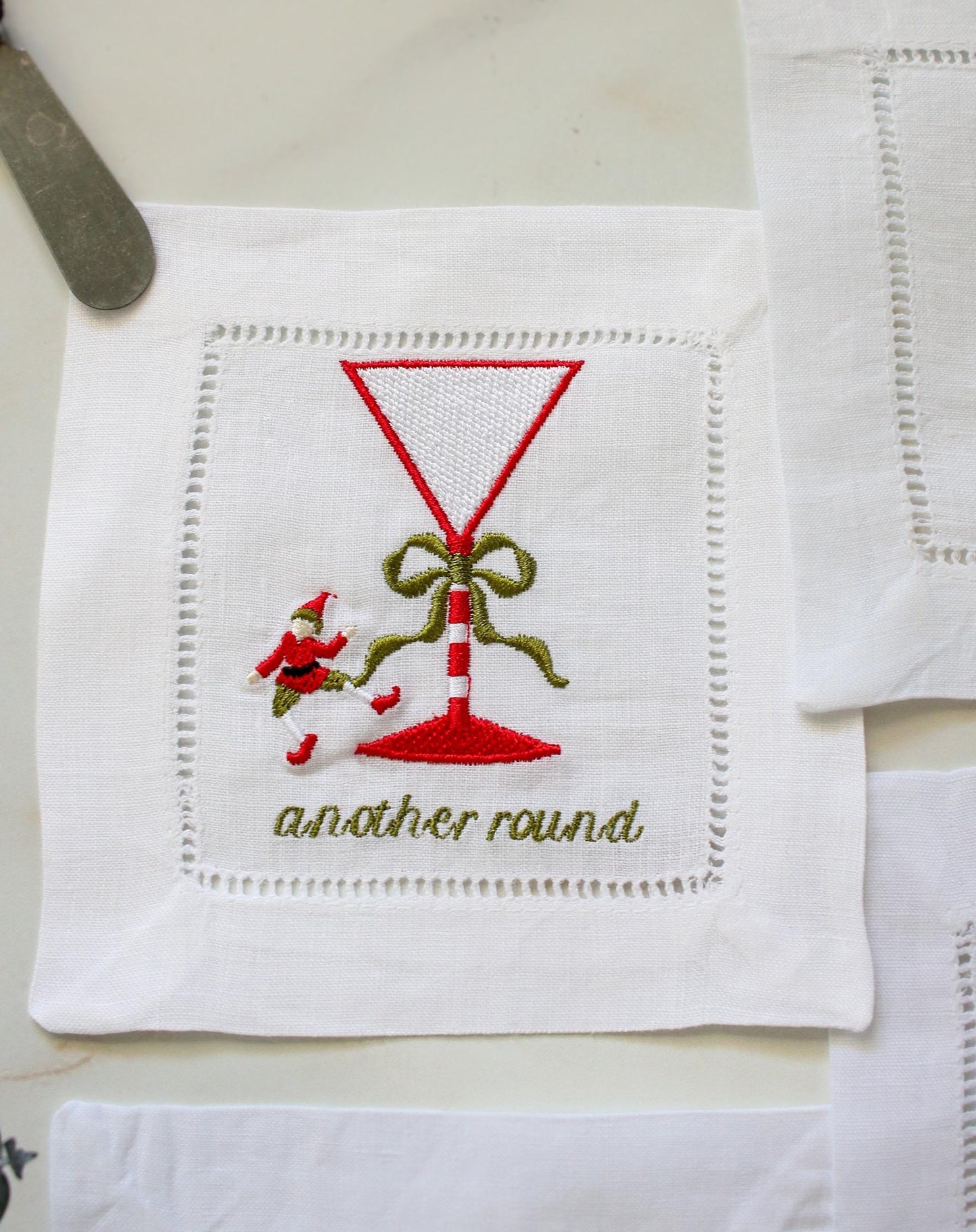 Christmas elf embroidered cocktail napkin – martini glass with candy cane stem, another round holiday linen coaster.