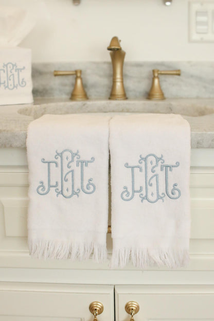 Set of monogrammed fingertip towels and tissue box cover in white cotton with ornate blue embroidery, personalized bathroom set.