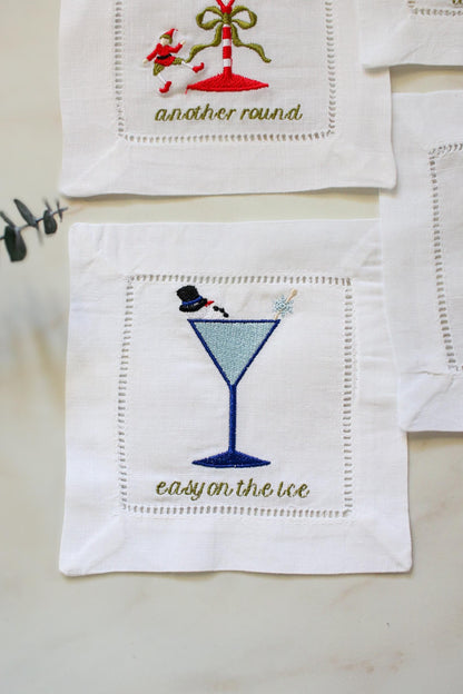 Snowman holiday cocktail napkin – embroidered martini glass with snowman and snowflake stir stick, easy on the ice.