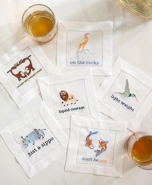 Funny embroidered linen cocktail napkins set of 6 with animal puns arranged around whiskey glasses